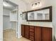 Bathroom featuring a vanity with a large mirror and a walk-in closet at 18637 W Fulton St, Goodyear, AZ 85338