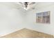 Bright bedroom with carpet flooring, a ceiling fan, and a window with blinds at 18637 W Fulton St, Goodyear, AZ 85338