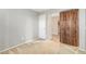 Bedroom featuring neutral paint and a sliding wooden door at 18637 W Fulton St, Goodyear, AZ 85338