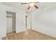 Bedroom with a ceiling fan and carpet flooring that includes an closet for storage at 18637 W Fulton St, Goodyear, AZ 85338