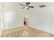 Bright bedroom featuring a ceiling fan, carpet, and an en-suite bathroom at 18637 W Fulton St, Goodyear, AZ 85338