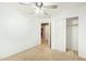 Bedroom featuring carpet flooring, a closet, a ceiling fan, and an en-suite bathroom at 18637 W Fulton St, Goodyear, AZ 85338