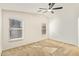 Bright bedroom with a ceiling fan, carpet flooring, and natural light from two windows at 18637 W Fulton St, Goodyear, AZ 85338