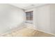 Bedroom featuring neutral paint and a window with blinds and carpet flooring at 18637 W Fulton St, Goodyear, AZ 85338