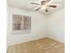 A bedroom with a ceiling fan, a window with blinds, and carpet flooring at 18637 W Fulton St, Goodyear, AZ 85338