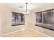 Well-lit dining area featuring tile flooring, neutral walls and a stylish chandelier at 18637 W Fulton St, Goodyear, AZ 85338