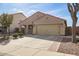 Charming single-story home featuring a two-car garage, desert landscaping, and a brick-lined walkway at 18637 W Fulton St, Goodyear, AZ 85338