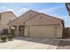 Charming single-story home featuring a two-car garage, desert landscaping, and a brick-lined walkway at 18637 W Fulton St, Goodyear, AZ 85338