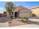 Charming single-story home featuring a two-car garage, desert landscaping, and a brick-lined walkway at 18637 W Fulton St, Goodyear, AZ 85338