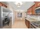 Bright kitchen showcasing granite countertops, stainless steel appliances, and wood cabinetry at 18637 W Fulton St, Goodyear, AZ 85338