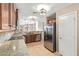 Open concept kitchen with stainless steel appliances, granite countertops, and tiled backsplash at 18637 W Fulton St, Goodyear, AZ 85338