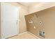 Laundry room with tile flooring, connections for appliances, and built-in shelves for storage at 18637 W Fulton St, Goodyear, AZ 85338