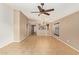 Spacious living room featuring neutral paint, tile flooring, ceiling fan, and an open layout at 18637 W Fulton St, Goodyear, AZ 85338