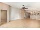 Spacious living room featuring neutral paint, tile flooring, ceiling fan, and an open layout at 18637 W Fulton St, Goodyear, AZ 85338