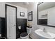 Modern half bathroom with stylish black and white decor and humorous wall art at 1899 W Prospector Way, San Tan Valley, AZ 85144