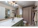 Bathroom with a large mirror, wood accents, and decorative shelving at 1899 W Prospector Way, San Tan Valley, AZ 85144