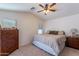 Bedroom with a ceiling fan and a dresser with decorative items at 1899 W Prospector Way, San Tan Valley, AZ 85144