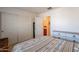 Bedroom featuring a patterned bedspread, closet doors, and view to the en-suite bathroom at 1899 W Prospector Way, San Tan Valley, AZ 85144