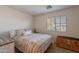 Bedroom boasts a patterned bedspread, trunk and view to the outside through the window at 1899 W Prospector Way, San Tan Valley, AZ 85144