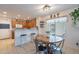 Bright dining area features a round wooden table and a view of the kitchen at 1899 W Prospector Way, San Tan Valley, AZ 85144