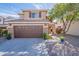 Charming two-story home featuring a two car garage, landscaping, and stone accents at 1899 W Prospector Way, San Tan Valley, AZ 85144