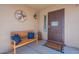 Cozy front porch with a wooden bench, pillows, and welcome mat at 1899 W Prospector Way, San Tan Valley, AZ 85144