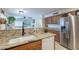 Bright kitchen featuring a breakfast bar, stainless steel refrigerator, and granite countertops at 1899 W Prospector Way, San Tan Valley, AZ 85144