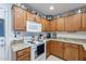 Traditional kitchen boasting granite countertops, white appliances, and oak cabinets at 1899 W Prospector Way, San Tan Valley, AZ 85144