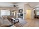 Comfortable living room with a large sectional sofa, TV, and arched doorway at 1899 W Prospector Way, San Tan Valley, AZ 85144