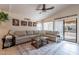 Spacious living room featuring a large sectional sofa, neutral colors, and sliding glass doors at 1899 W Prospector Way, San Tan Valley, AZ 85144