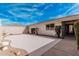 The side courtyard features white brick walls, desert landscaping, and concrete patio at 19817 N Ponderosa Cir, Sun City, AZ 85373