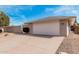 The exterior of a well-maintained home, highlighting a spacious two-car garage with a clean, modern design at 19817 N Ponderosa Cir, Sun City, AZ 85373