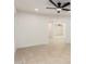 Spacious living room showing the neutral-colored walls, tile floors, and ceiling fan at 19817 N Ponderosa Cir, Sun City, AZ 85373