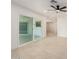 Bright and airy living room with neutral tile flooring, ceiling fan, and access to the back yard at 19817 N Ponderosa Cir, Sun City, AZ 85373