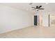 Main bedroom with tile floors and entrance to a renovated bathroom at 19817 N Ponderosa Cir, Sun City, AZ 85373