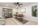 Well-lit home office with a modern ceiling fan, sleek shelving, and ample workspace for productivity at 19817 N Ponderosa Cir, Sun City, AZ 85373