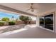 Covered patio offering a serene outdoor living space with a landscaped backyard view at 19817 N Ponderosa Cir, Sun City, AZ 85373