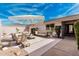 Outdoor patio with lounge seating, umbrella, and manicured landscaping perfect for relaxing or entertaining guests at 19817 N Ponderosa Cir, Sun City, AZ 85373