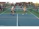 Outdoor pickleball court with players in action and spectators in the background at 19817 N Ponderosa Cir, Sun City, AZ 85373