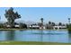 A pond with a fountain provides a serene backdrop with views of nearby houses and trees at 19817 N Ponderosa Cir, Sun City, AZ 85373