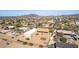 Wide shot from above shows how house and workshop integrate into community, offering parking and desert landscape views at 205 E Irvine Rd, Phoenix, AZ 85086