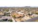 A desert home and shop offer convenient parking and storage opportunities in this spacious property surrounded by desert terrain at 205 E Irvine Rd, Phoenix, AZ 85086