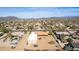 Aerial picture showing a desert house and workshop in a developed community with distant views of Arizona landscape at 205 E Irvine Rd, Phoenix, AZ 85086