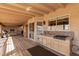 Spacious back porch with a built-in outdoor cooking area, perfect for relaxing and entertaining guests at 205 E Irvine Rd, Phoenix, AZ 85086