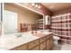 Traditional bathroom with double sinks, neutral colors, and decorative accents at 205 E Irvine Rd, Phoenix, AZ 85086