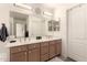 Bathroom featuring a double sink vanity with ample counter space and a large mirror at 205 E Irvine Rd, Phoenix, AZ 85086