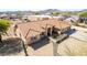 Aerial shot of the beautiful single-Gathering home; tile roof, desert landscape, mountain backdrop, and spacious three-car garage at 205 E Irvine Rd, Phoenix, AZ 85086