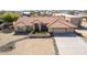 Aerial view of the single-Gathering house highlighting a well-maintained landscape, tile roof, three-car garage, and desert surroundings at 205 E Irvine Rd, Phoenix, AZ 85086