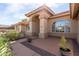 Charming front porch with tile flooring, potted plants and stone landscaping accents at 205 E Irvine Rd, Phoenix, AZ 85086