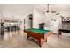 Spacious game room with a pool table, open concept, and neutral tile flooring at 205 E Irvine Rd, Phoenix, AZ 85086